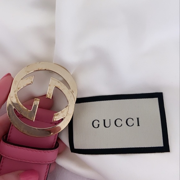 Pink Gucci belt with interlocking G buckle.
